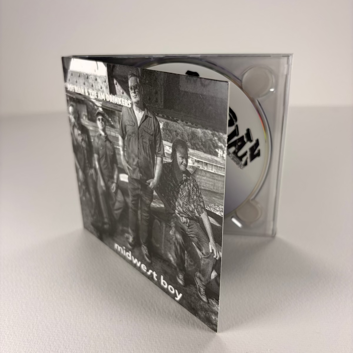 CD packaging with a black and white photo of four people on a white background