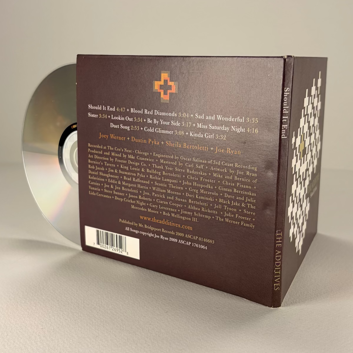 CD with its packaging on a neutral background