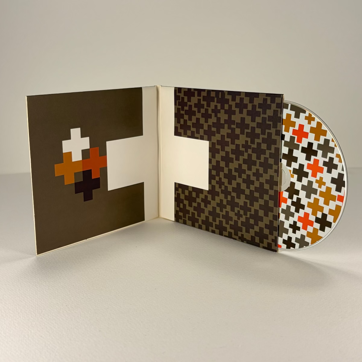 Vinyl record with a patterned cover on a plain background